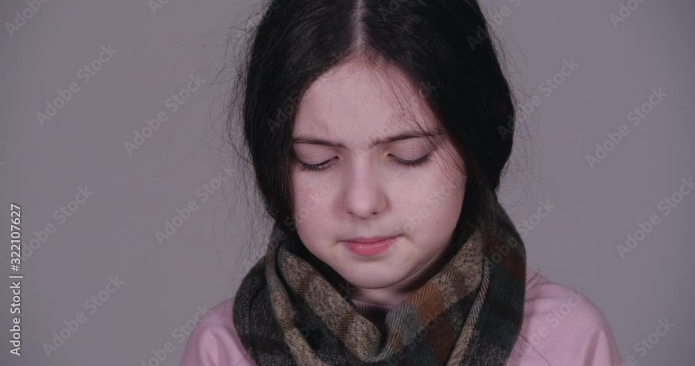 Little girl suffering from cold on grey background, closeup Little girl suffering from cold on grey background, closeup