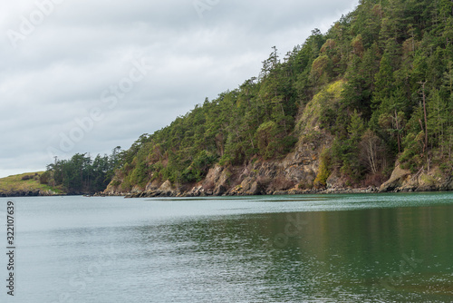 Landscape of water and hillside covered in trees at Bowman Bay on Fidalgo Island in Washington