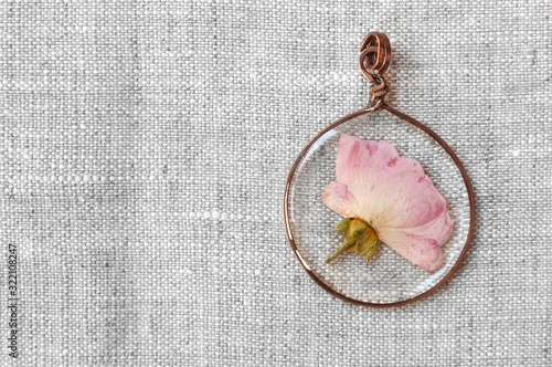 handmade epoxy resin jewelry. pendant, rose in copper frame.
