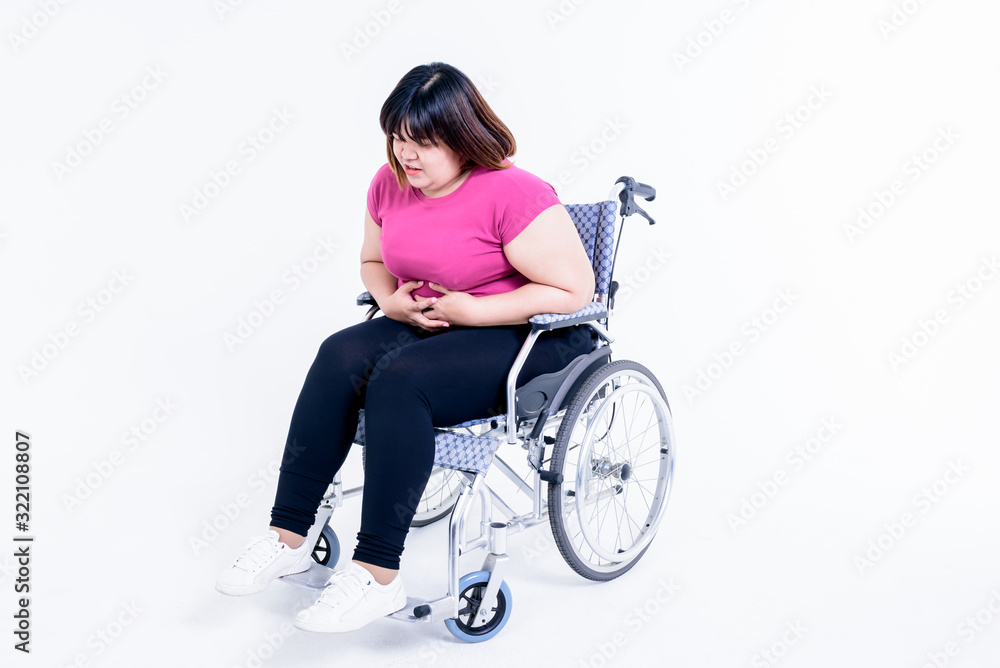 Portrait images, Asian fat woman sitting on a wheelchair have pain in the stomach are from gastritis, On white background to health care concept. Portrait images, Asian fat woman sitting on a wheelchair have pain in the stomach are from gastritis, On white background to health care concept.
