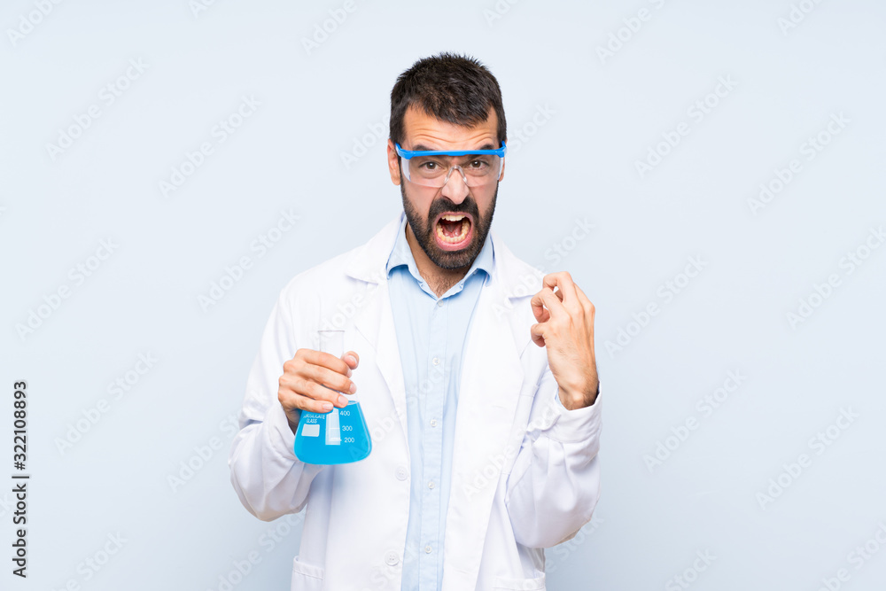 Young scientific holding laboratory flask over isolated background frustrated by a bad situation Young scientific holding laboratory flask over isolated background frustrated by a bad situation