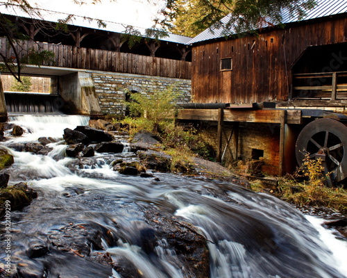 Fototapeta Naklejka Na Ścianę i Meble -  Bridge over river beside an old mill. Seasonal colors in Ontario, Canada.
