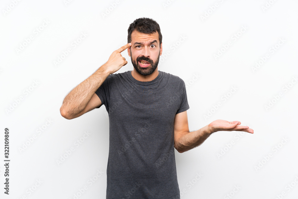 Young handsome man over isolated white background making the gesture of madness putting finger on the head Young handsome man over isolated white background making the gesture of madness putting finger on the head