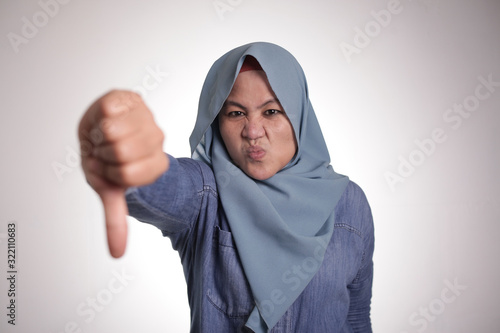 Muslim Lady Shows Thumbs Down Gesture, Disappointed Expression