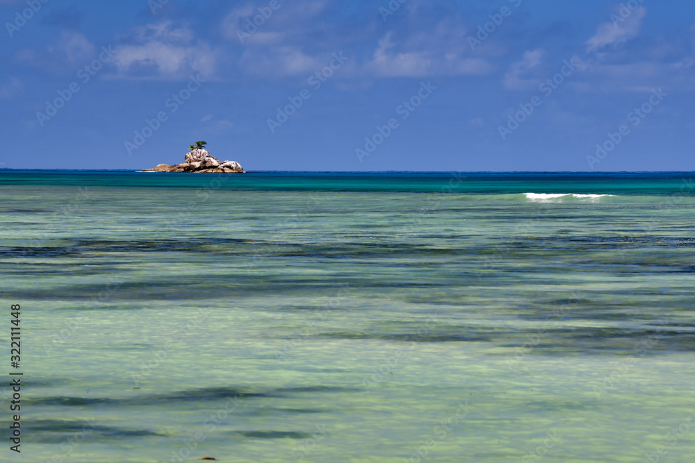 Ocean waves, turquoise water and blue sky.  Mahe Island Seychelles.