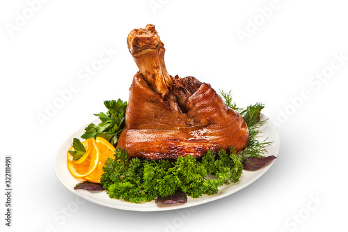 Baked pork, whole leg, a huge portion with a crispy appetizing crust on a white table. isolated background photo