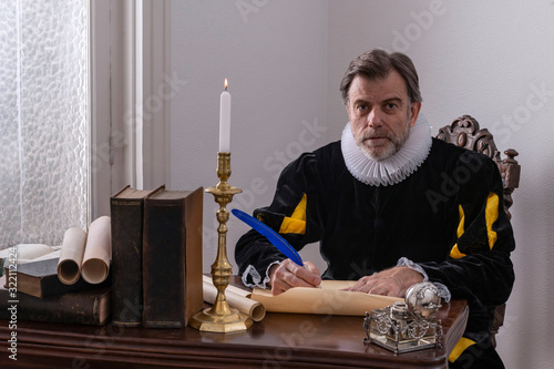 Recreation of a writer of the Spanish Golden Age (1492 to 1659), writing at his desk photo