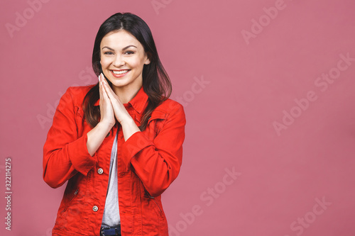 Portrait of amazed shocked young woman isolated over pink background.