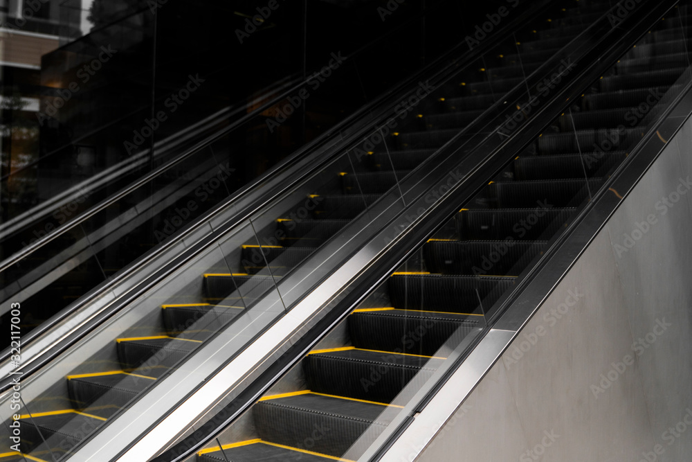 Empty escalators stairway with a yellow stripes. Empty escalators stairway with a yellow stripes.