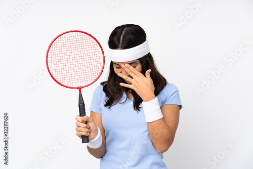 Young badminton player woman over isolated white background laughing © luismolinero