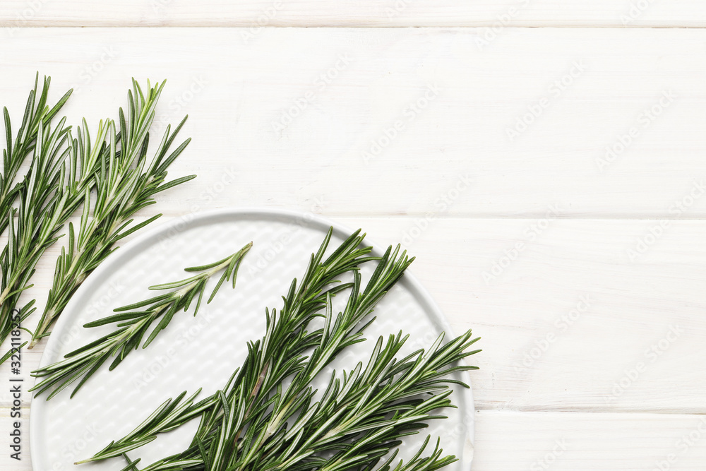 Flat lay composition with fresh rosemary on wooden background, space for text Flat lay composition with fresh rosemary on wooden background, space for text
