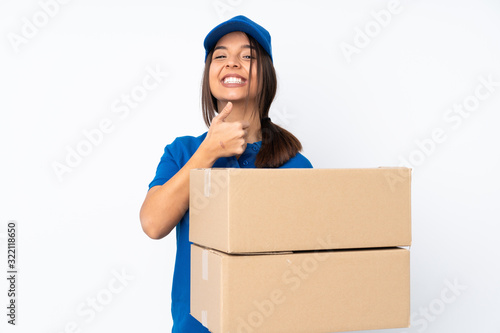 Young delivery brunette girl over isolated white background giving a thumbs up gesture