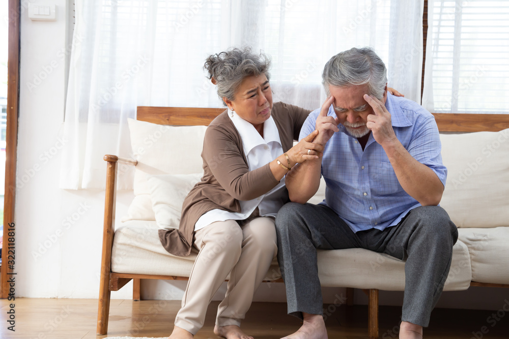 Asian senior retired couple holding hands and take care together at home, Alzheimer disease or suffering with dementia concept Asian senior retired couple holding hands and take care together at home, Alzheimer disease or suffering with dementia concept