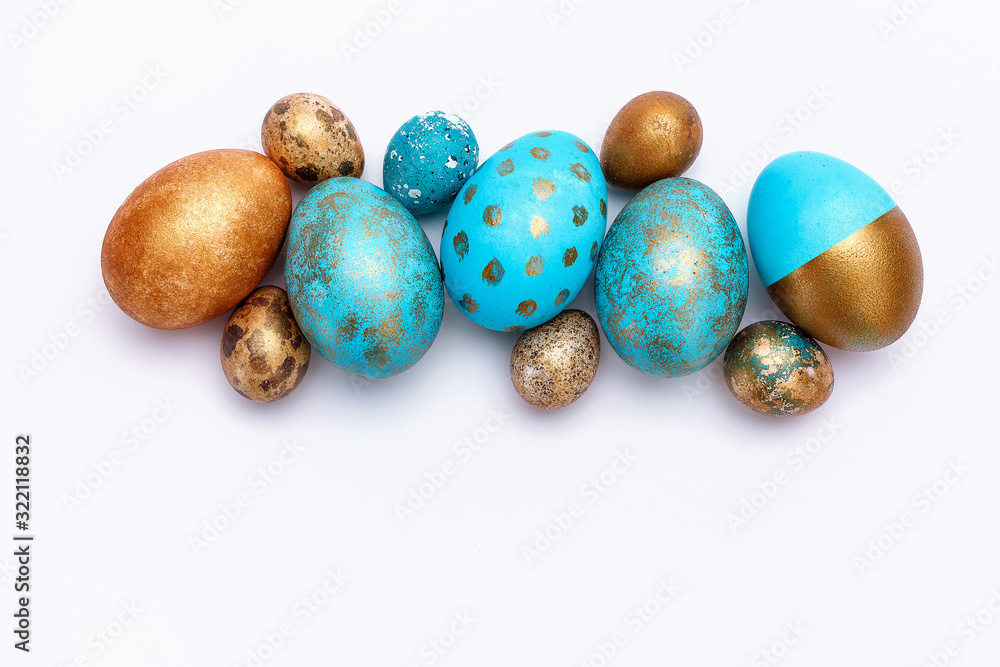 Blue and golden modern easter eggs on a white background. Many objects. Top view. Isolated. Blue and golden modern easter eggs on a white background. Many objects. Top view. Isolated.