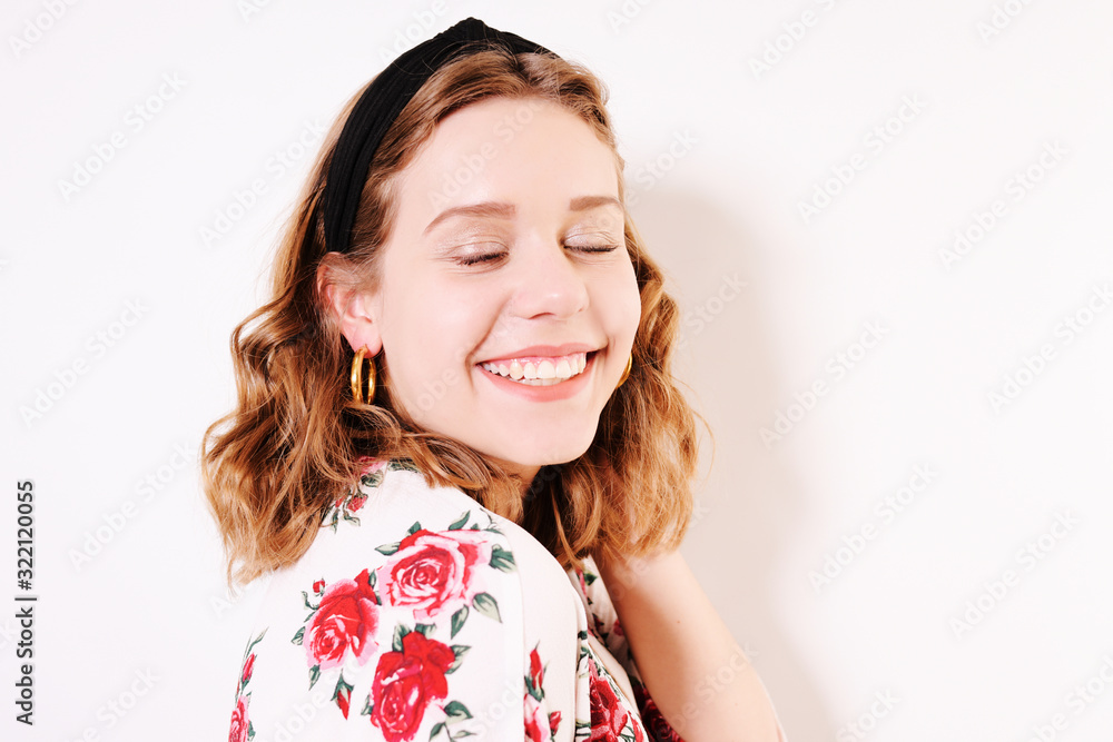 Incredibly cute teen girl smiles and looks away. A beautiful headband, a girl with short hair, a brown-haired woman, a blonde, a place for text Incredibly cute teen girl smiles and looks away. A beautiful headband, a girl with short hair, a brown-haired woman, a blonde, a place for text