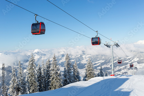 Modern ski gondola in an Austrian ski resort on a snowy winter day.
