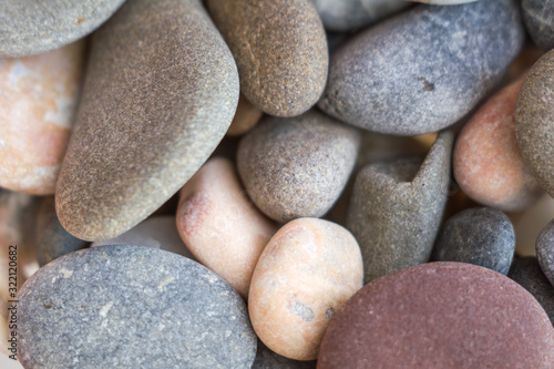 Different sizes and colors stones abstract background or texture. Closeup view. Selective soft focus
