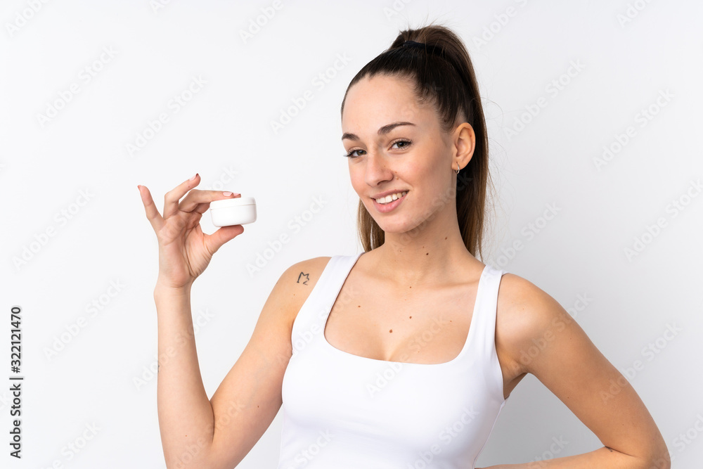 Young brunette woman over isolated white background with moisturizer Young brunette woman over isolated white background with moisturizer