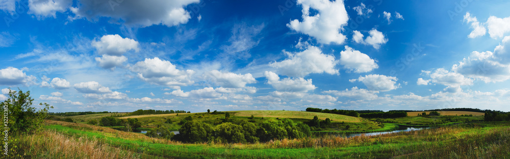 Summer panoramic view of fields and trees