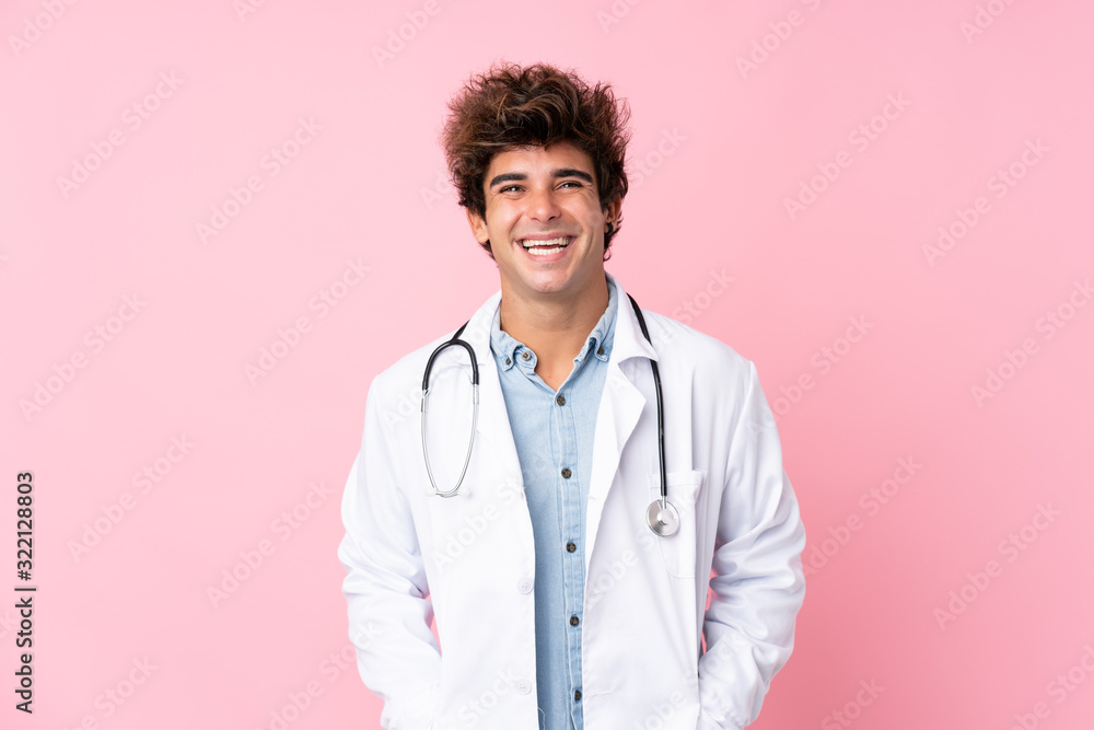 Young caucasian man over isolated pink background with doctor gown Young caucasian man over isolated pink background with doctor gown