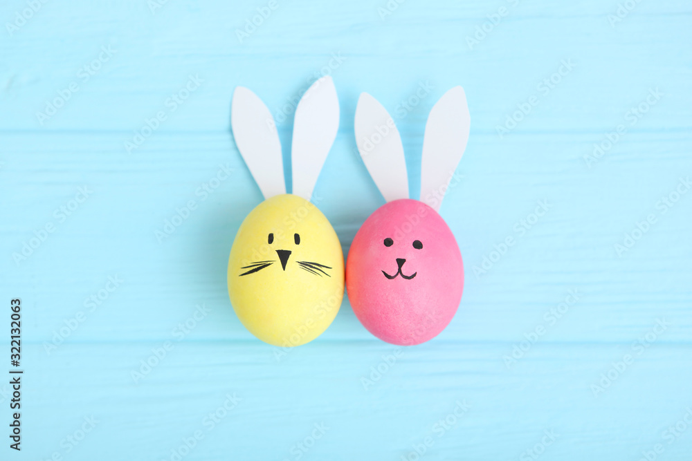 Easter eggs with cute faces and ears on a colored background. Easter eggs with cute faces and ears on a colored background.