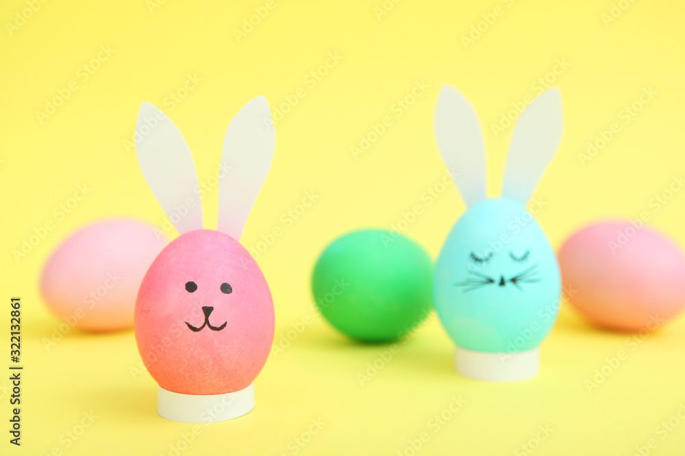 Easter eggs with cute faces and ears on a colored background. Easter eggs with cute faces and ears on a colored background.