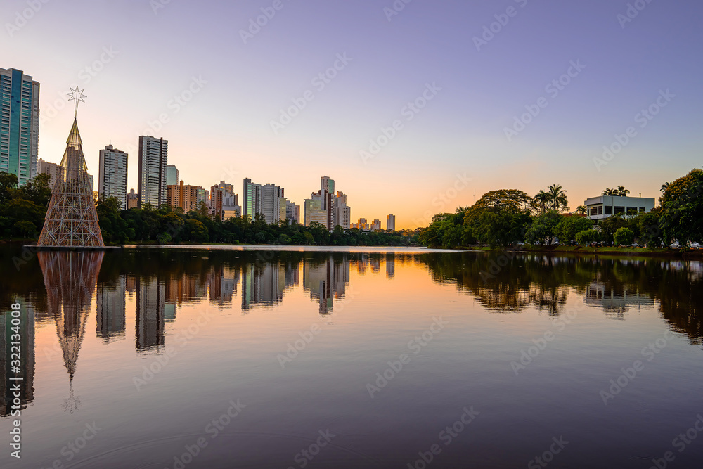 Beautiful sunset at Igapo lake, Londrina PR Brazil. Water of the lake and buildings of the city on the photo.