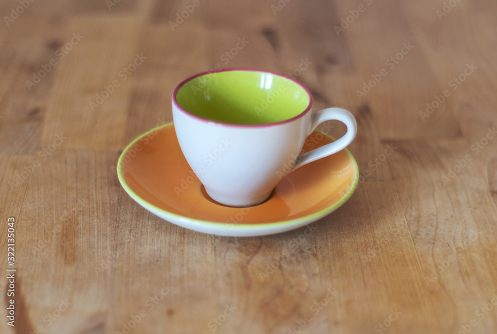 Porcelain cup with plate on the wooden table Porcelain cup with plate on the wooden table