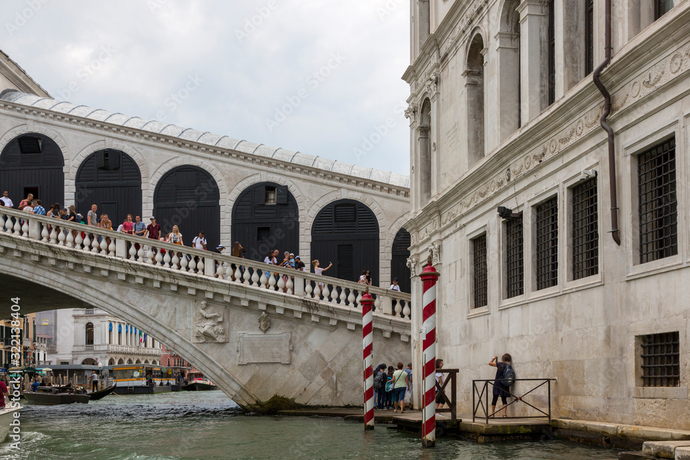 People on the Rialto Bridge over the Grand Canal in Venice