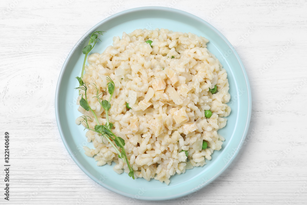 Delicious risotto with cheese on white wooden table, top view Delicious risotto with cheese on white wooden table, top view