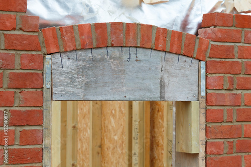 Brick laying building a brick arch