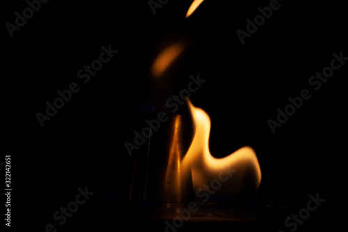 Flame texture on a dark background. The tongue of the flame is warm.