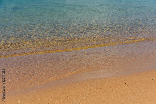 Closeup of the sand on beach and Red sea water