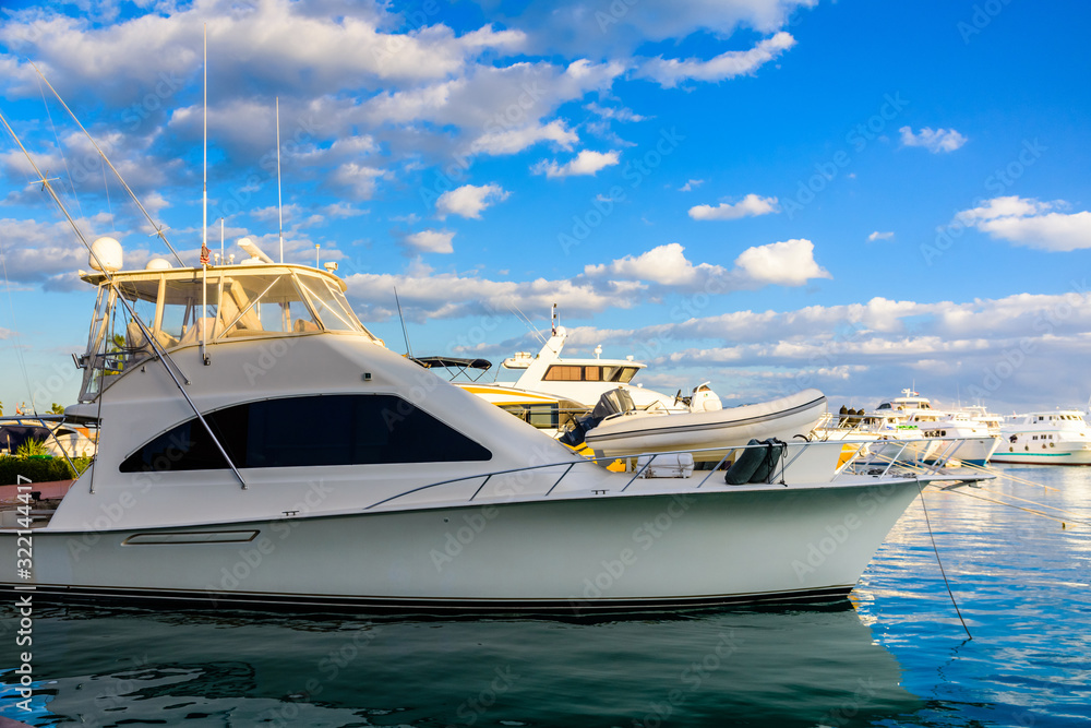 Naklejka premium White luxury yacht in a sea harbor of Hurghada, Egypt. Marina with tourist boats on Red Sea
