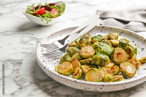 Delicious roasted brussels sprouts on white marble table