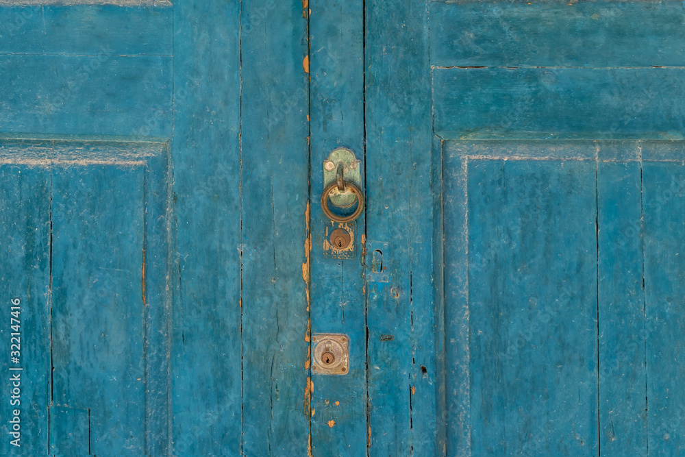 blue wooden door with round handle