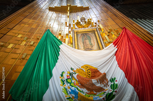 Our Lady of Guadalupe with mexican flag in Mexico City photo