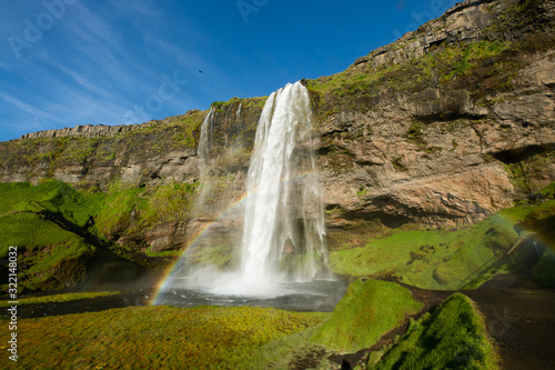 Scenic Seljalandsfoss waterfall with rainbow © ilyaska