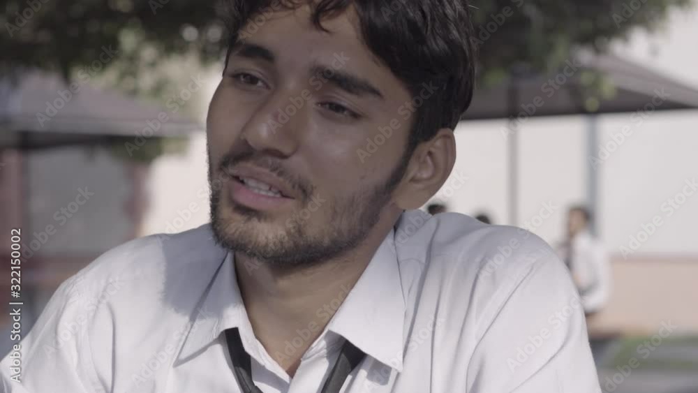 Indian college student talking to his friends. Indian university student.Facial expression of a Indian man Indian college student talking to his friends. Indian university student.Facial expression of a Indian man