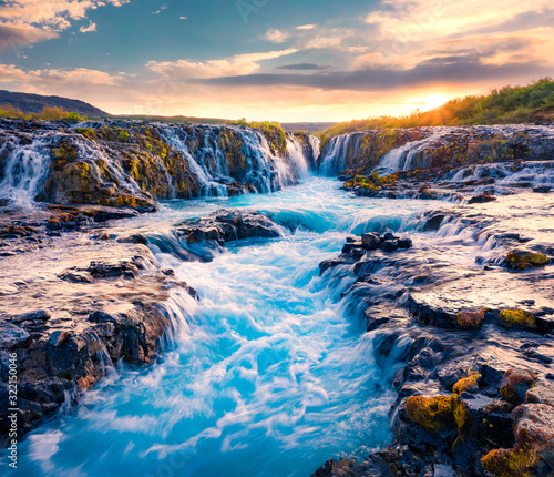Spectacular summer view of Bruarfoss Waterfall, secluded spot with cascading blue waters. Superb sunrise in Iceland, Europe. Beauty of nature concept background..