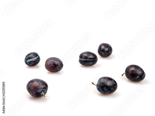 Organic purple plums on a white background.