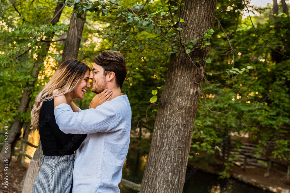 Couple of smiling lovers walk in a park. Couple of smiling lovers walk in a park.