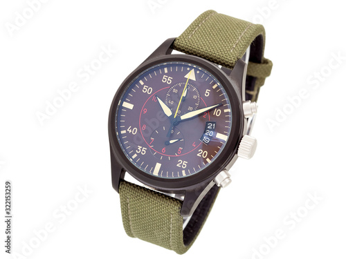 wristwatch with a green textile strap and brown iron case with arrows and numbers, isolated face of a watch on a white background.