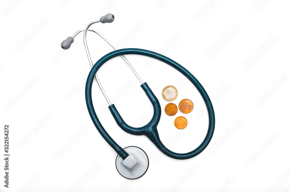 un fonendo (estetoscopio) azul , utensilio médico, junto a dinero (monedas de euro) bajo un fondo blanco. sanidad privada, hospital público, vender la salud, economía. un fonendo (estetoscopio) azul , utensilio médico, junto a dinero (monedas de euro) bajo un fondo blanco. sanidad privada, hospital público, vender la salud, economía.