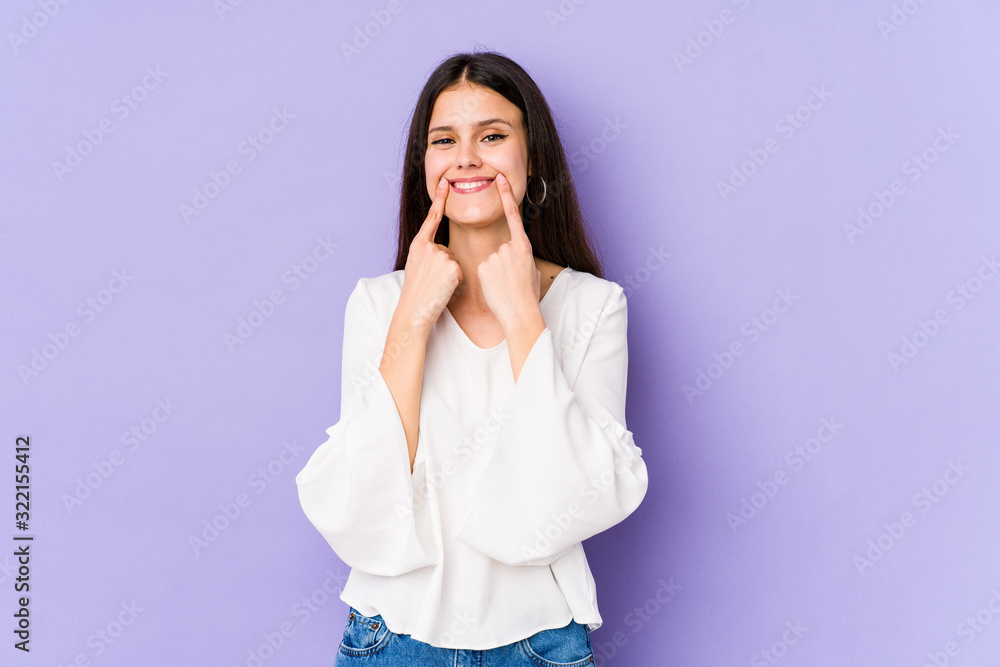 Young caucasian woman isolated on purple background doubting between two options. Young caucasian woman isolated on purple background doubting between two options.