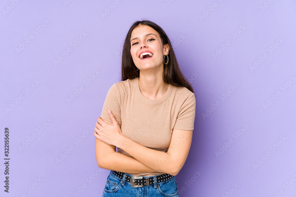 Young caucasian woman isolated on purple background laughing and having fun. Young caucasian woman isolated on purple background laughing and having fun.