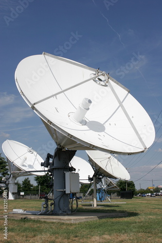 Satellite dishes against blue sky