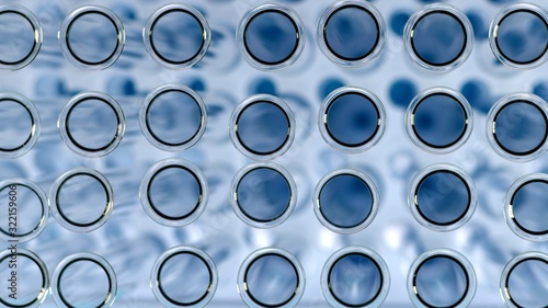Circles of necks from glass test tubes in blue view from above.