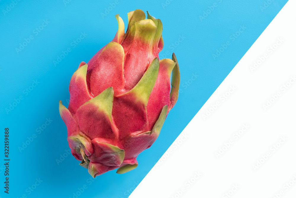 Fototapeta premium dragon fruit, pitaya, lies on a turquoise background, divided into white. Proper nutrition. Diet.