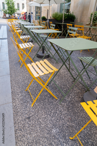 Charming south medieval city sidewalk cafe outdoor restaurant cafe tables in Avignon France © OceanProd